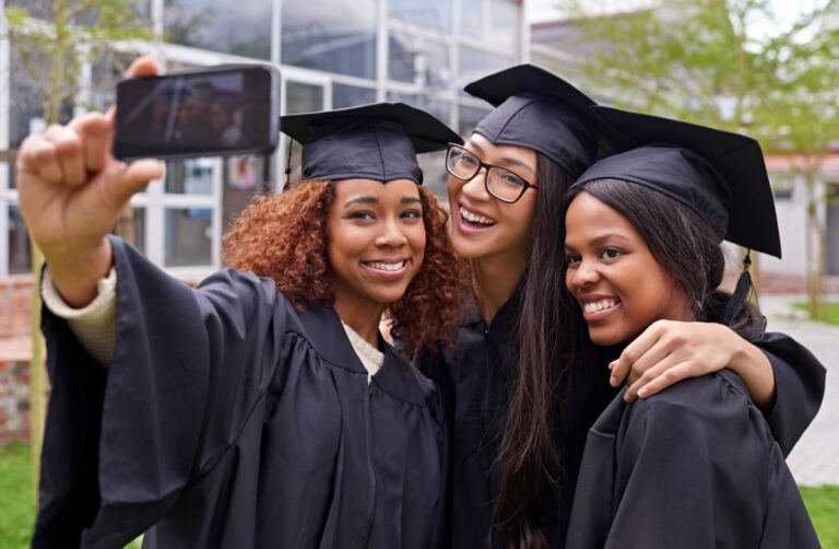 3 women hs grads at ceremony 1024x669